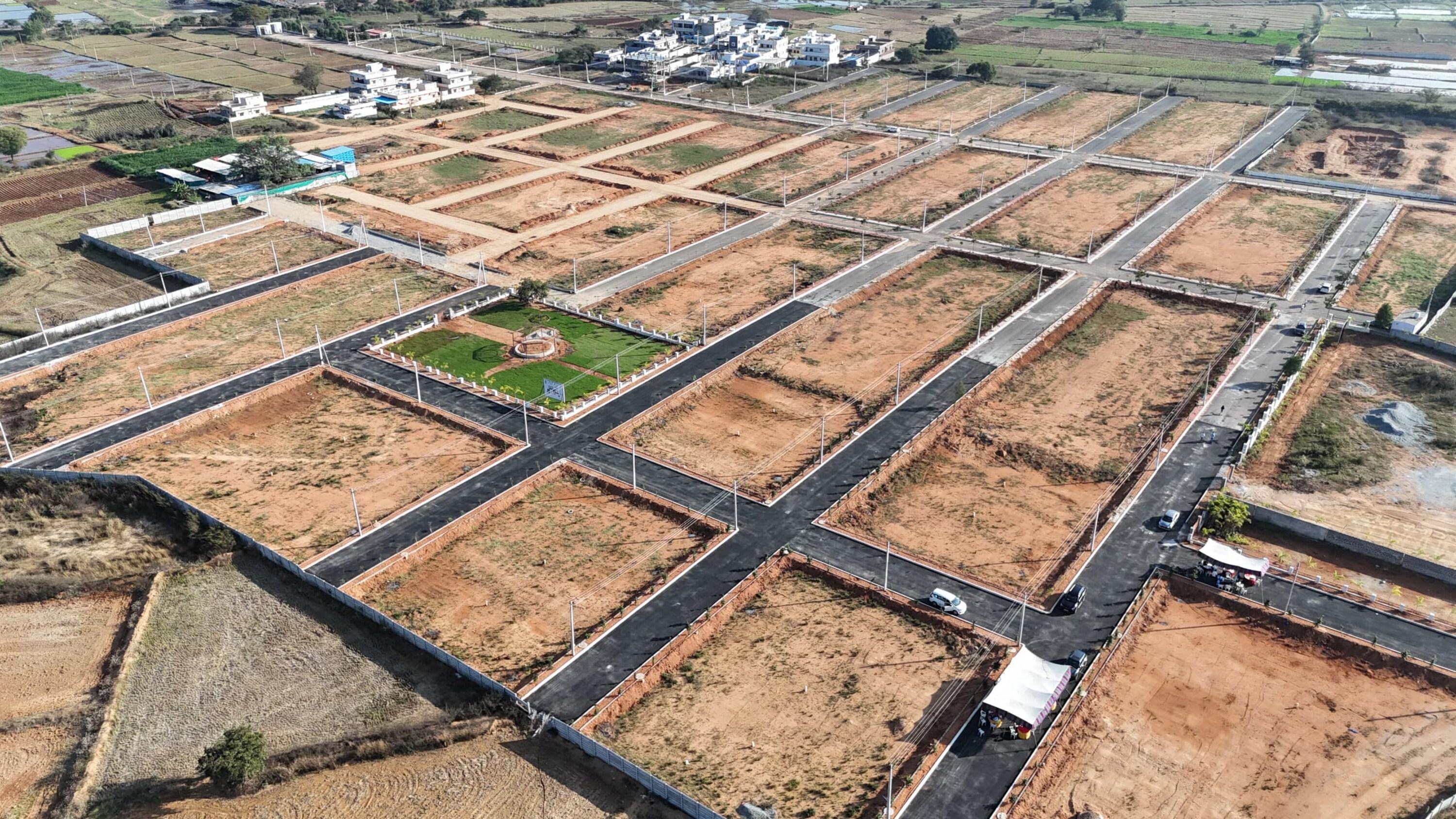 Open residential plots surrounded by greenery